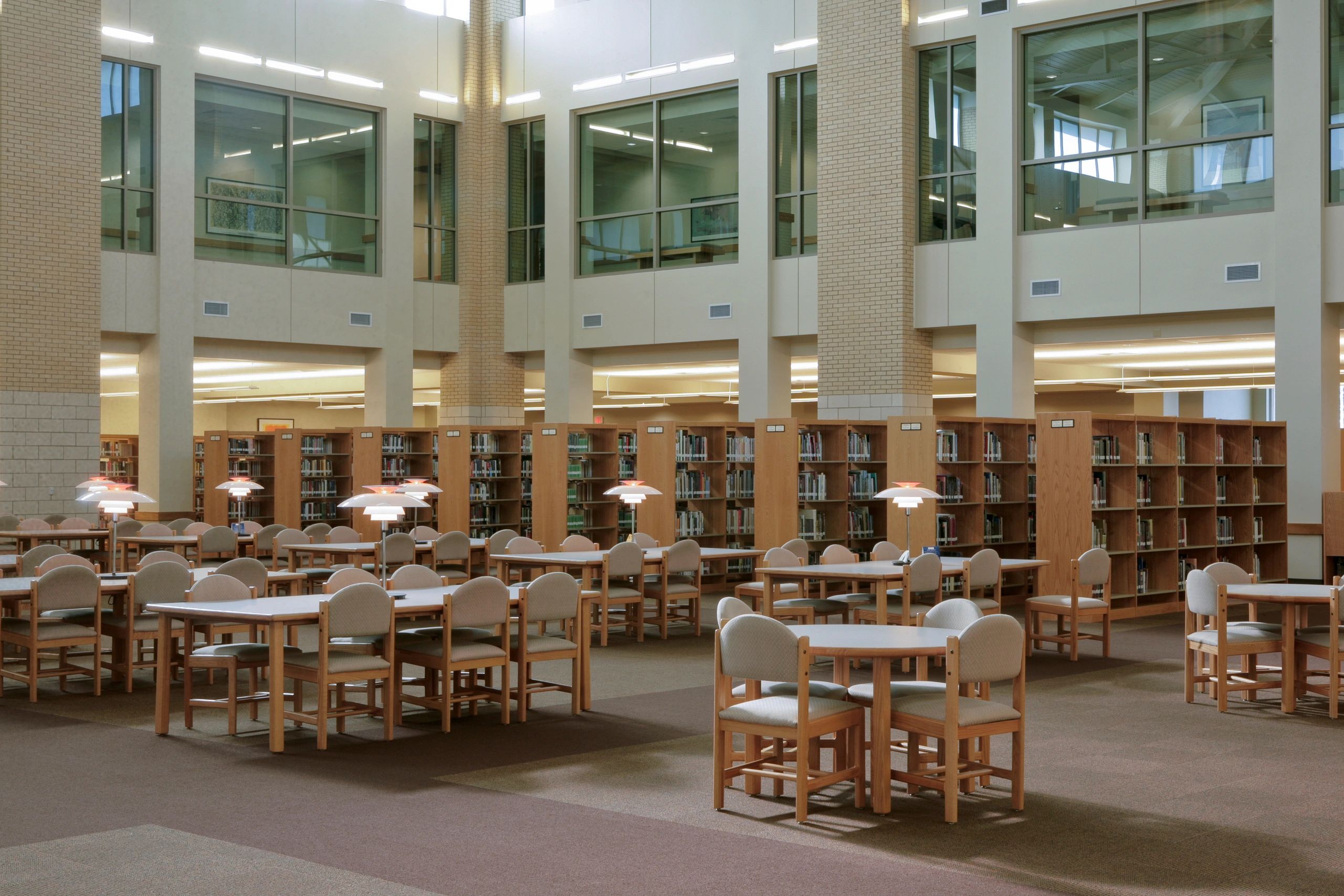 Scholarly library interior with tall shelves and study space
