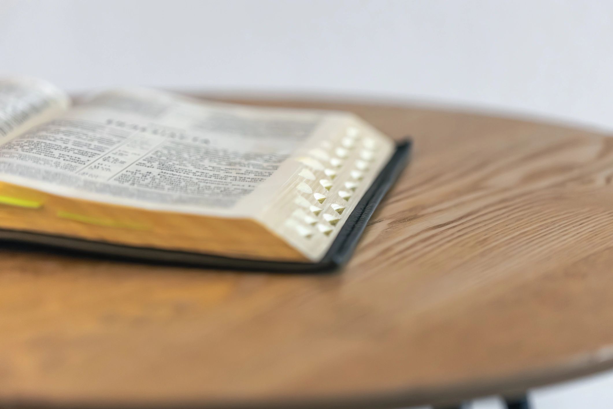 Open Bible on a wooden table for close study